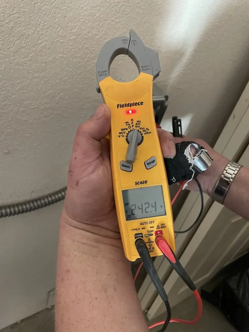 Voltage testing with clamp meter during Whole House Surge Protector in West End-Cobb Town